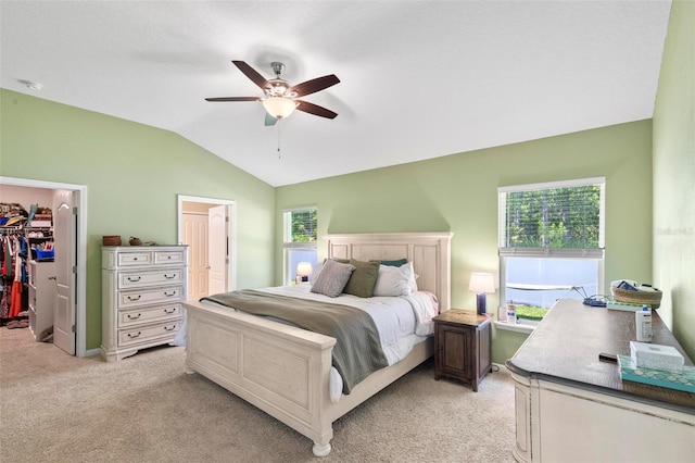 65 Lob Wedge Ln, Bunnell, FL 32110 - bedroom featuring a walk in closet, light carpet, lofted ceiling, and multiple windows