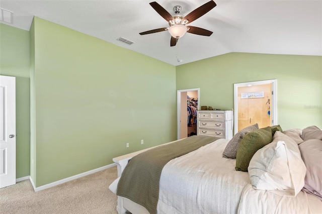 65 Lob Wedge Ln, Bunnell, FL 32110 - bedroom featuring a walk in closet, light carpet, lofted ceiling, baseboards, and a closet