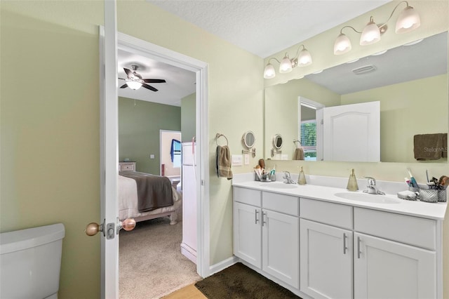 65 Lob Wedge Ln, Bunnell, FL 32110 - ensuite bathroom featuring double vanity, toilet, and ceiling fan