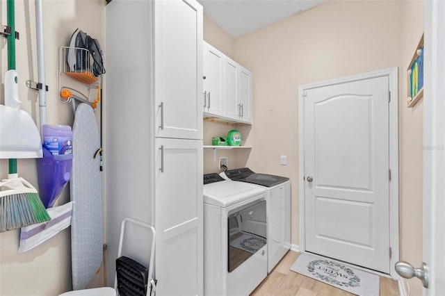 65 Lob Wedge Ln, Bunnell, FL 32110 - washroom with independent washer and dryer, cabinet space, and light wood-type flooring