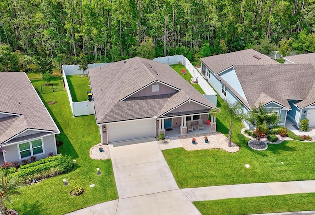 65 Lob Wedge Ln, Bunnell, FL 32110 - view of front of home with driveway, an attached garage, and a shingled roof