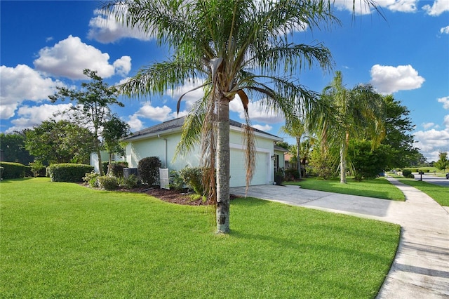 775 Blackmoor Gate Ln, Saint Augustine, FL 32084 - view of property exterior with driveway, a lawn, a garage, and stucco siding