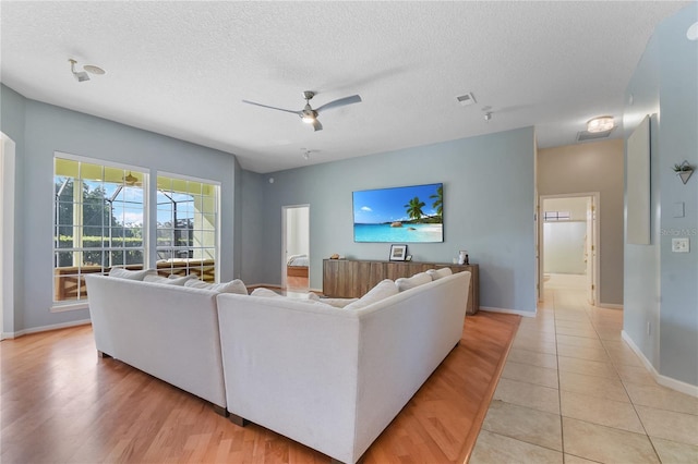 775 Blackmoor Gate Ln, Saint Augustine, FL 32084 - living room with baseboards, a ceiling fan, a textured ceiling, and light tile patterned floors