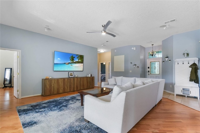 775 Blackmoor Gate Ln, Saint Augustine, FL 32084 - living room featuring a textured ceiling, wood finished floors, ceiling fan, baseboards, and a chandelier