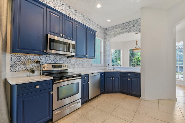 775 Blackmoor Gate Ln, Saint Augustine, FL 32084 - kitchen featuring appliances with stainless steel finishes, blue cabinetry, a sink, plenty of natural light, and recessed lighting