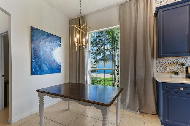 775 Blackmoor Gate Ln, Saint Augustine, FL 32084 - dining space featuring a chandelier, light tile patterned flooring, and baseboards