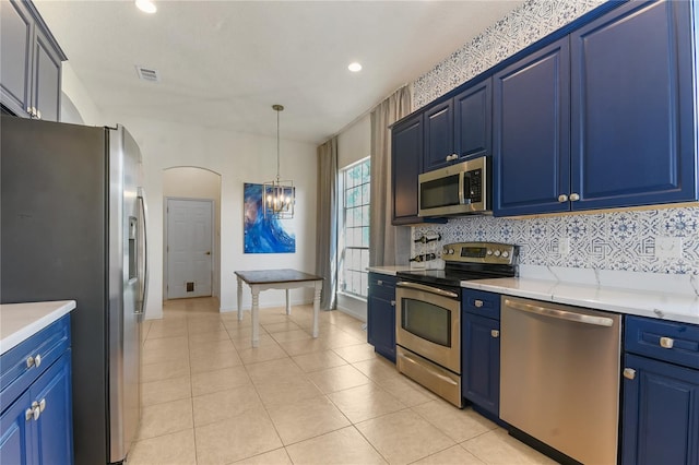 775 Blackmoor Gate Ln, Saint Augustine, FL 32084 - kitchen featuring stainless steel appliances, blue cabinets, arched walkways, tasteful backsplash, and recessed lighting