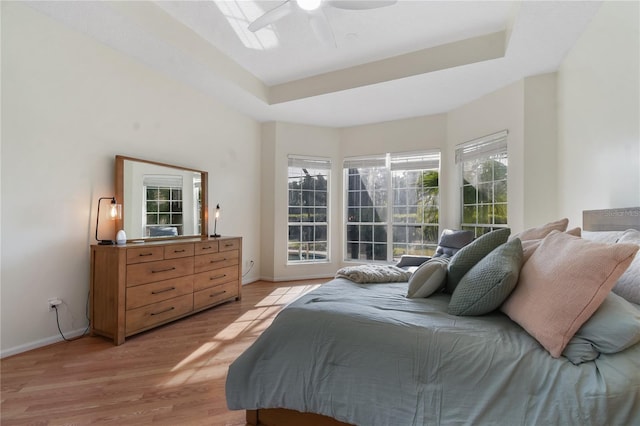 775 Blackmoor Gate Ln, Saint Augustine, FL 32084 - bedroom featuring baseboards, light wood-type flooring, a raised ceiling, and ceiling fan