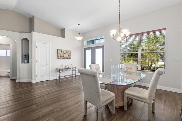 8 Buttermill Dr, Palm Coast, FL 32137 - dining area with arched walkways, french doors, dark wood-style floors, baseboards, and lofted ceiling