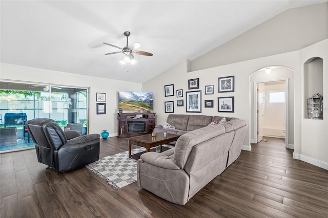8 Buttermill Dr, Palm Coast, FL 32137 - living area featuring ceiling fan, arched walkways, dark wood finished floors, baseboards, and a glass covered fireplace