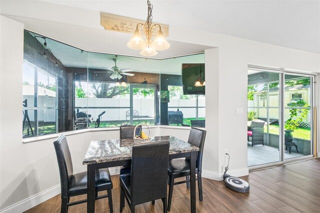 8 Buttermill Dr, Palm Coast, FL 32137 - dining area with baseboards, a chandelier, wood finished floors, and ceiling fan