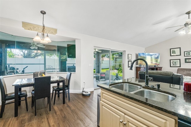 8 Buttermill Dr, Palm Coast, FL 32137 - kitchen featuring ceiling fan, a sink, dark wood finished floors, vaulted ceiling, and dark stone counters