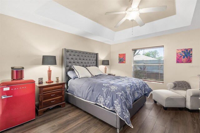 8 Buttermill Dr, Palm Coast, FL 32137 - bedroom featuring a raised ceiling, wood finished floors, and a ceiling fan