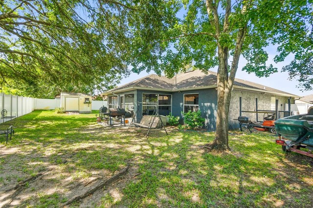 8 Buttermill Dr, Palm Coast, FL 32137 - back of property featuring a fenced backyard and stucco siding