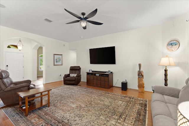 58 Slocum Path, Palm Coast, FL 32164 - living area featuring arched walkways, ceiling fan, and wood finished floors