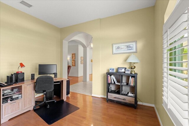 58 Slocum Path, Palm Coast, FL 32164 - office space with arched walkways, light wood finished floors, and baseboards