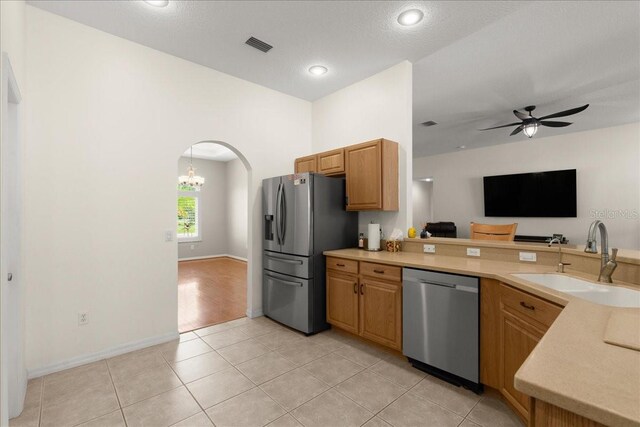 58 Slocum Path, Palm Coast, FL 32164 - kitchen with stainless steel appliances, a sink, light countertops, light tile patterned flooring, and a peninsula