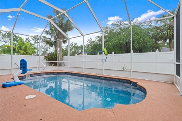 58 Slocum Path, Palm Coast, FL 32164 - view of pool with a fenced backyard, glass enclosure, and a patio