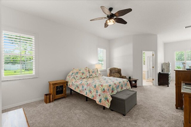 58 Slocum Path, Palm Coast, FL 32164 - carpeted bedroom featuring a ceiling fan and connected bathroom