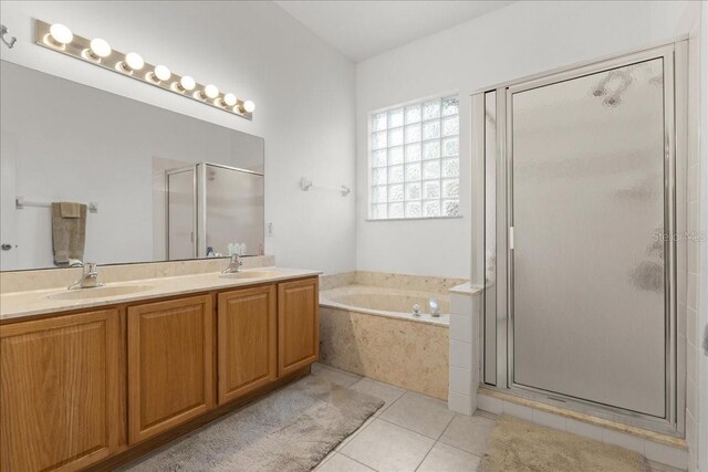58 Slocum Path, Palm Coast, FL 32164 - bathroom with a stall shower, a bath, double vanity, and tile patterned flooring