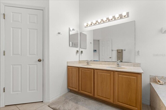 58 Slocum Path, Palm Coast, FL 32164 - bathroom featuring double vanity, tile patterned floors, and baseboards