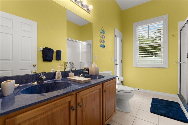 58 Slocum Path, Palm Coast, FL 32164 - full bathroom with a stall shower, double vanity, tile patterned floors, toilet, and baseboards