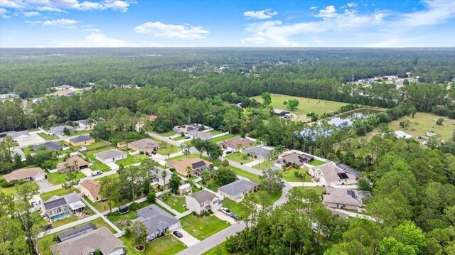 58 Slocum Path, Palm Coast, FL 32164 - aerial view of property and surrounding area featuring a forest and nearby suburban area