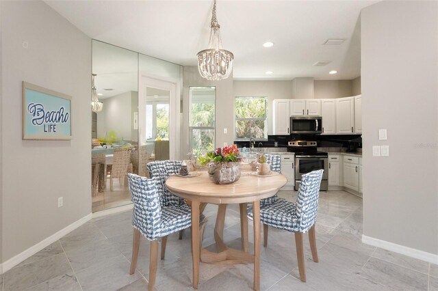 45 Atlantic Dr, Palm Coast, FL 32137 - dining room with a chandelier, baseboards, and recessed lighting