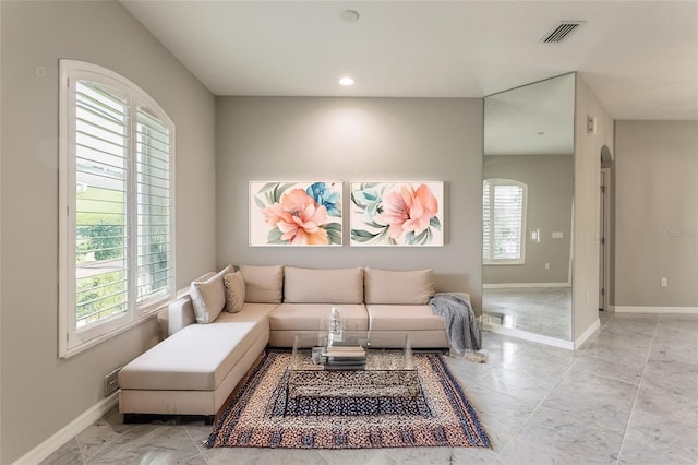 45 Atlantic Dr, Palm Coast, FL 32137 - living area with baseboards, arched walkways, recessed lighting, and light marble finish floors