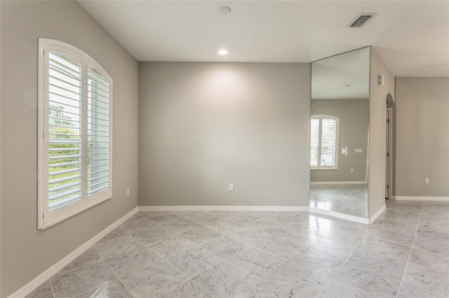 45 Atlantic Dr, Palm Coast, FL 32137 - empty room featuring baseboards, recessed lighting, and arched walkways