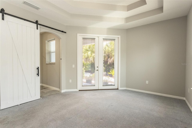 45 Atlantic Dr, Palm Coast, FL 32137 - empty room with a barn door, carpet floors, and french doors