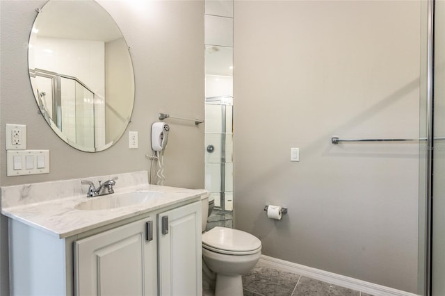 45 Atlantic Dr, Palm Coast, FL 32137 - bathroom featuring vanity, toilet, baseboards, tile patterned flooring, and a shower with door