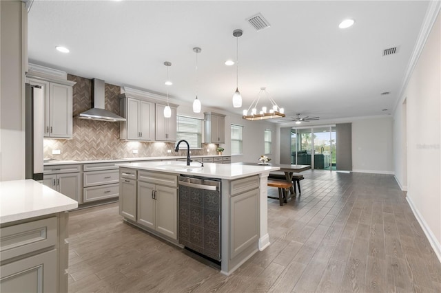 13 Las Brisas Way, Palm Coast, FL 32137 - kitchen with wall chimney exhaust hood, ornamental molding, gray cabinets, light countertops, and recessed lighting