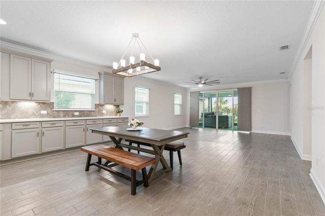 13 Las Brisas Way, Palm Coast, FL 32137 - dining area featuring plenty of natural light, ornamental molding, light wood-style flooring, ceiling fan, and baseboards