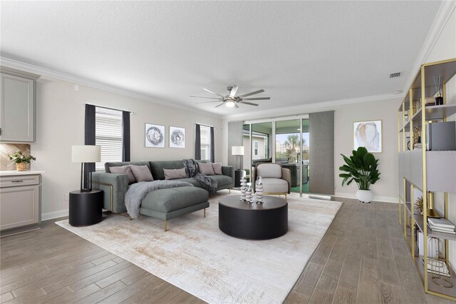 13 Las Brisas Way, Palm Coast, FL 32137 - living room with wood-type flooring, crown molding, a ceiling fan, baseboards, and a textured ceiling