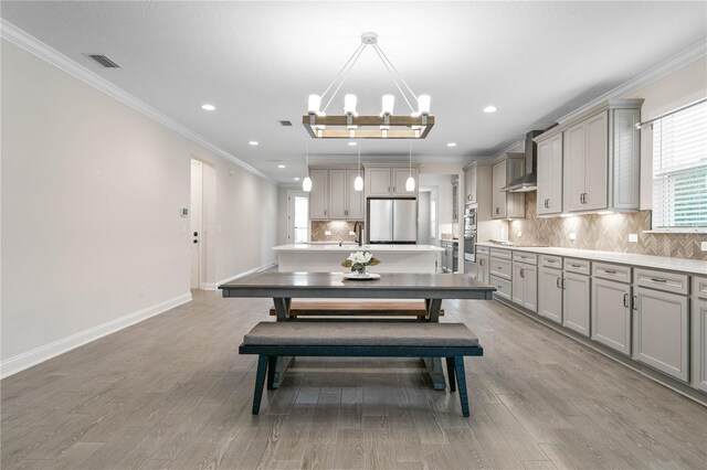 13 Las Brisas Way, Palm Coast, FL 32137 - dining area with light wood-type flooring, baseboards, crown molding, recessed lighting, and a chandelier