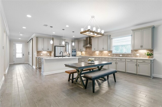 13 Las Brisas Way, Palm Coast, FL 32137 - dining space featuring ornamental molding, healthy amount of natural light, light wood-style floors, recessed lighting, and baseboards