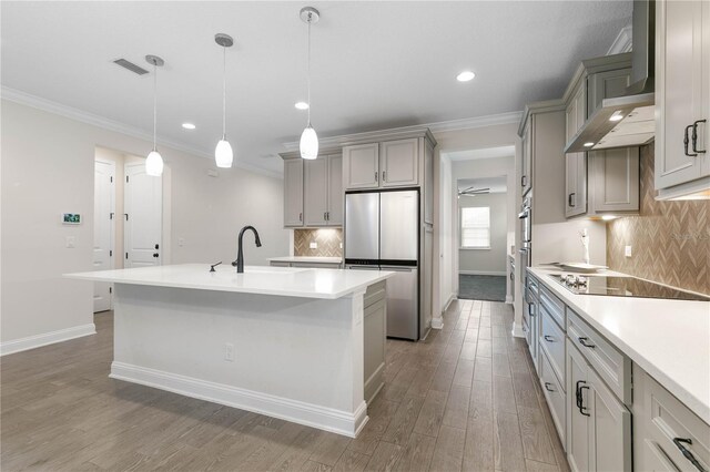 13 Las Brisas Way, Palm Coast, FL 32137 - kitchen featuring freestanding refrigerator, wall chimney range hood, black electric stovetop, baseboards, and wood finished floors