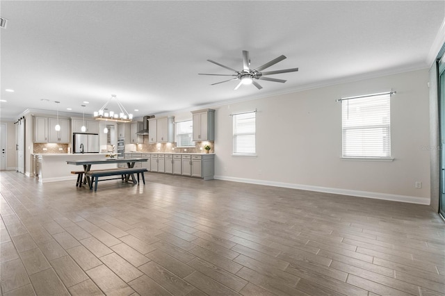 13 Las Brisas Way, Palm Coast, FL 32137 - living area with ornamental molding, a ceiling fan, wood finished floors, a chandelier, and baseboards