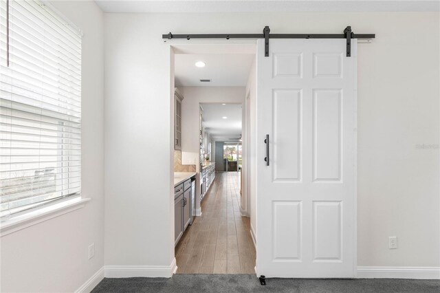13 Las Brisas Way, Palm Coast, FL 32137 - hall with a barn door, baseboards, and recessed lighting