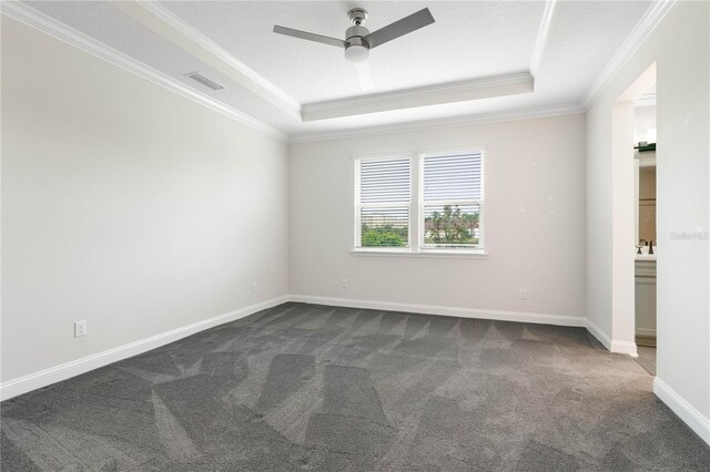 13 Las Brisas Way, Palm Coast, FL 32137 - empty room featuring a raised ceiling, ornamental molding, dark colored carpet, ceiling fan, and baseboards