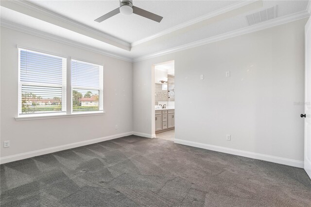 13 Las Brisas Way, Palm Coast, FL 32137 - unfurnished room with crown molding, dark colored carpet, ceiling fan, baseboards, and a raised ceiling