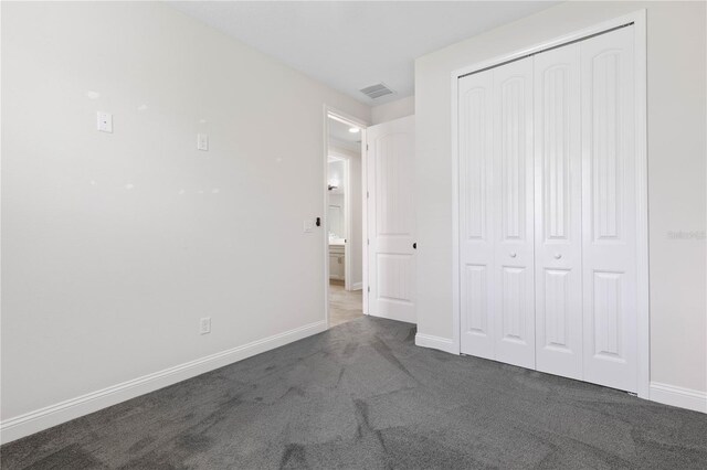 13 Las Brisas Way, Palm Coast, FL 32137 - unfurnished bedroom with carpet, baseboards, and a closet
