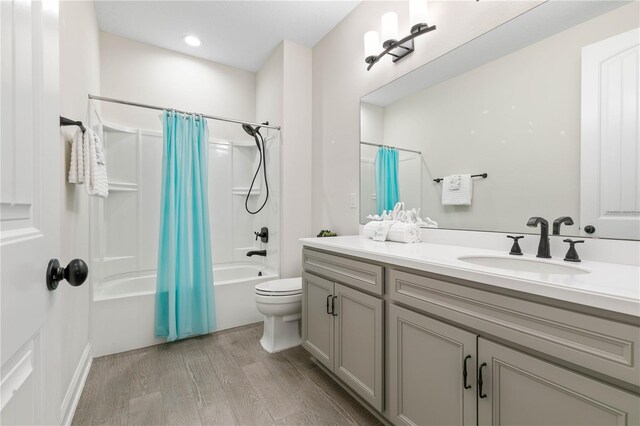 13 Las Brisas Way, Palm Coast, FL 32137 - full bathroom featuring wood finished floors, vanity, shower / tub combo, toilet, and recessed lighting