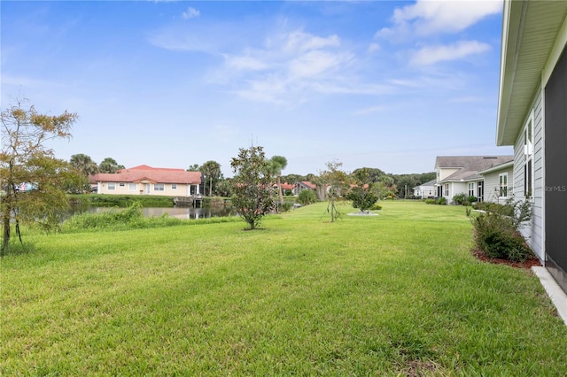 13 Las Brisas Way, Palm Coast, FL 32137 - view of green lawn featuring a water view and a residential view