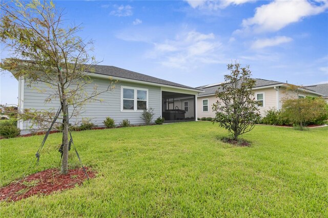 13 Las Brisas Way, Palm Coast, FL 32137 - back of property with a lawn and a sunroom