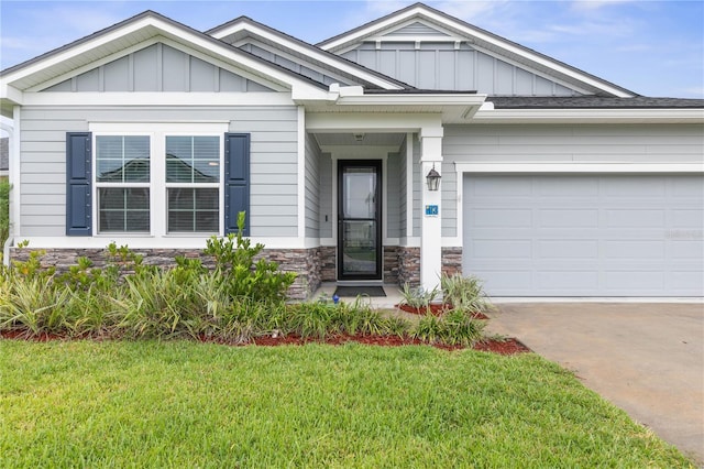 13 Las Brisas Way, Palm Coast, FL 32137 - craftsman-style home featuring driveway, board and batten siding, stone siding, a front lawn, and an attached garage
