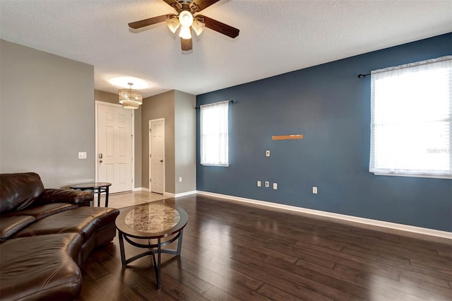 1 Rockwell Ln W, Palm Coast, FL 32164 - living room featuring a ceiling fan, a textured ceiling, wood finished floors, and baseboards