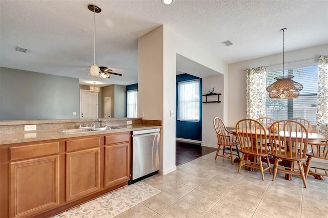 1 Rockwell Ln W, Palm Coast, FL 32164 - kitchen featuring stainless steel dishwasher, a textured ceiling, ceiling fan, pendant lighting, and a sink
