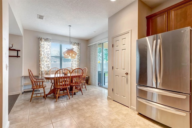 1 Rockwell Ln W, Palm Coast, FL 32164 - dining area featuring light tile patterned flooring, a textured ceiling, a chandelier, and baseboards